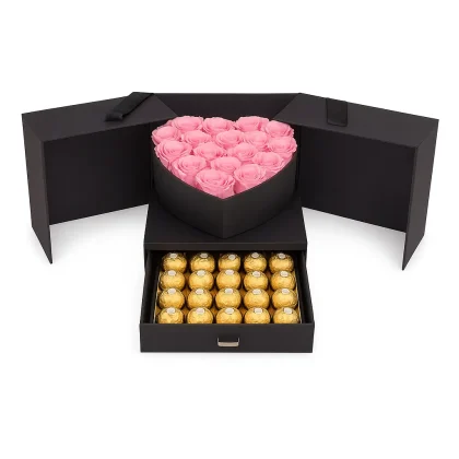 Dafaa Al Ward by Laviola Flowers – elegant black box with pink heart-shaped roses and Ferrero Rocher chocolates, a luxurious floral gift symbolizing love and warmth.
