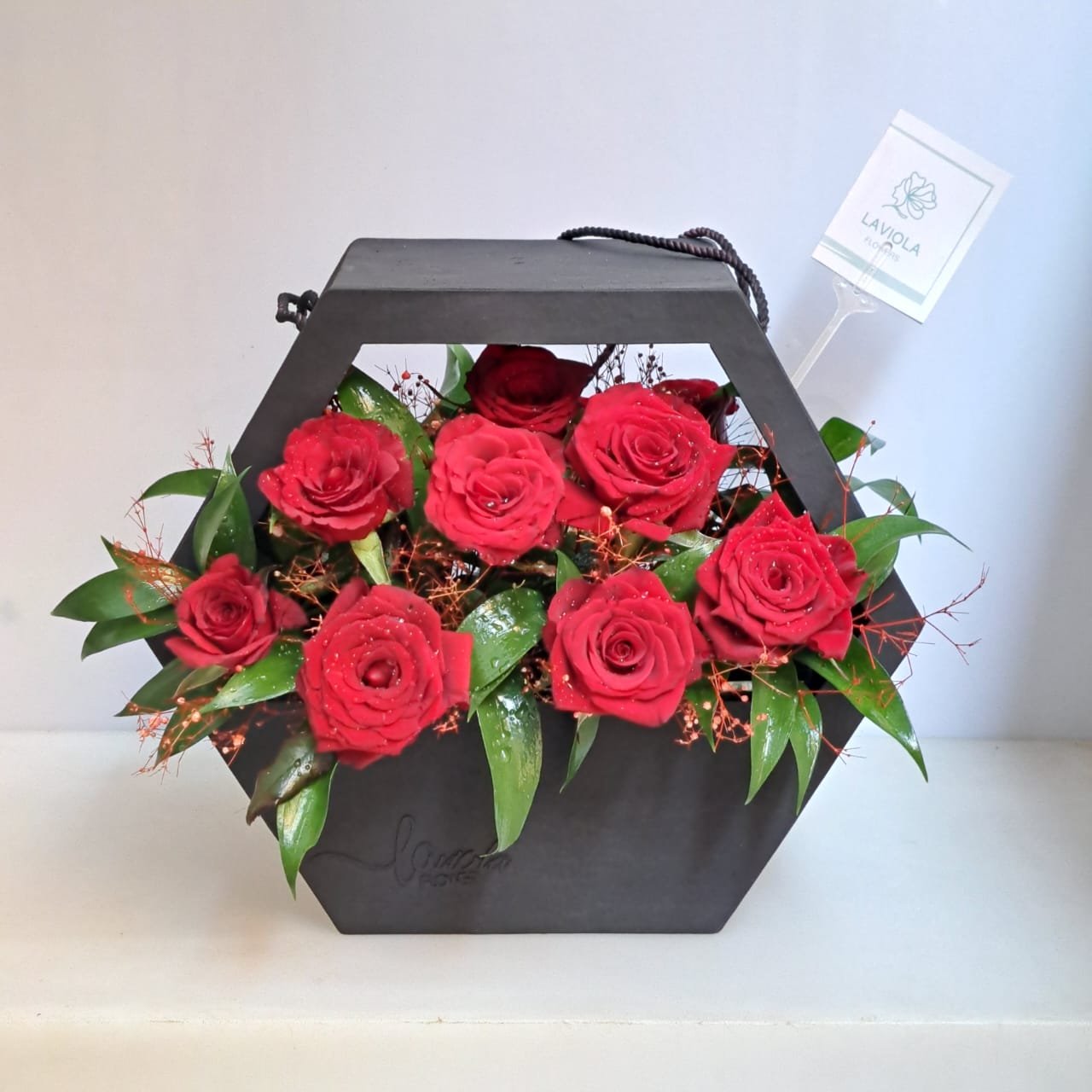 Black ribbed box and red rose