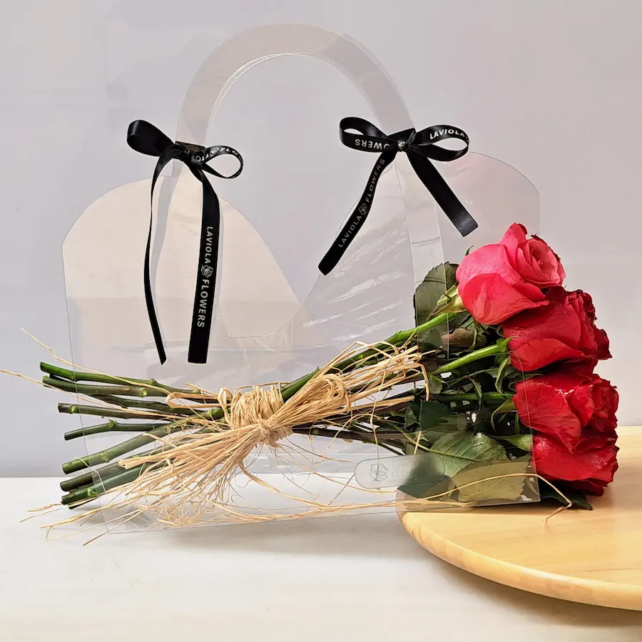 Luxury red roses bouquet in elegant transparent bag by Laviola Flowers